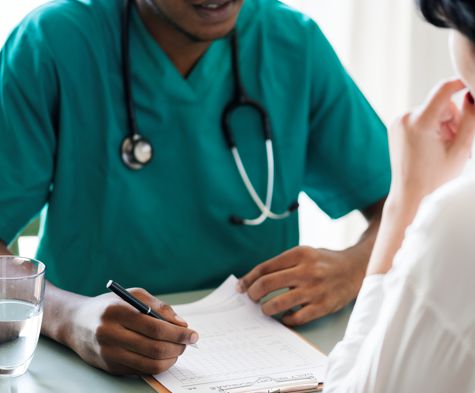 Doctor writing a diagnosis for a patient